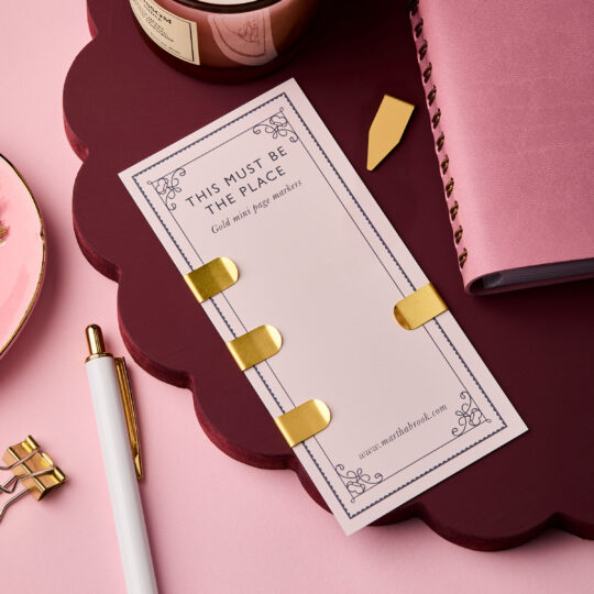 martha brook personalised stationery gold mini page markers on a burgundy scalloped stand